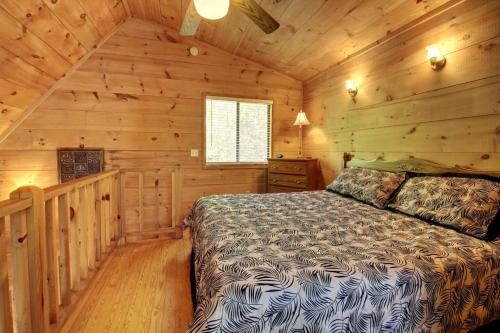 a bedroom with a bed in a log cabin at Bavarian Hideaway 24 in Sautee Nacoochee