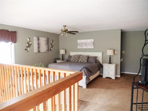 a bedroom with a bed and a ceiling fan at Rivers Edge Condo 101 in Helen