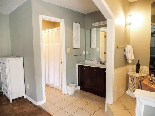 a bathroom with a sink and a mirror at Rivers Edge Condo 101 in Helen