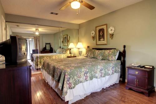 a bedroom with two beds and a flat screen tv at Rivers Edge 504 in Helen