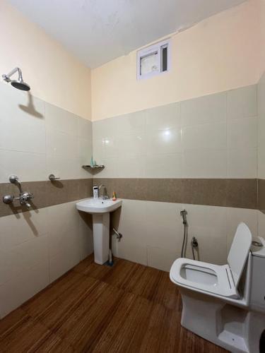 a bathroom with a toilet and a sink at Yugm Homes Rishikesh in Narendranagar