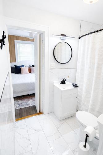 ein Badezimmer mit Waschbecken, Toilette und Bett in der Unterkunft Broad Ripple Home witth Hot Tub Near Downtown Indy in Indianapolis