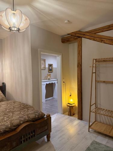 a bedroom with a bed and a desk in a room at Haus der Geschichten in Marienberg