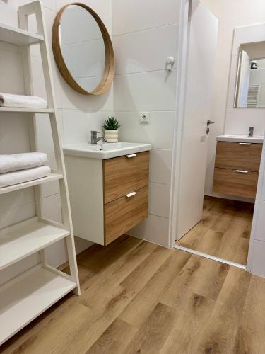 a bathroom with a sink and a mirror at City Apartment 920 in Pardubice