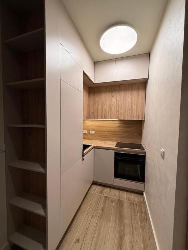 a kitchen with white cabinets and a light fixture at SkyHill Jahorina Gondola Poljice Newly Opened in Jahorina