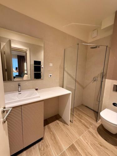 a bathroom with a sink and a shower and a toilet at SkyHill Jahorina Gondola Poljice Newly Opened in Jahorina
