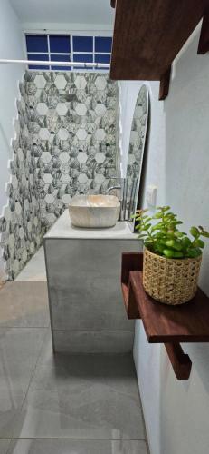 a bathroom with a counter with a sink and a window at Finca El Monasterio in Rivas