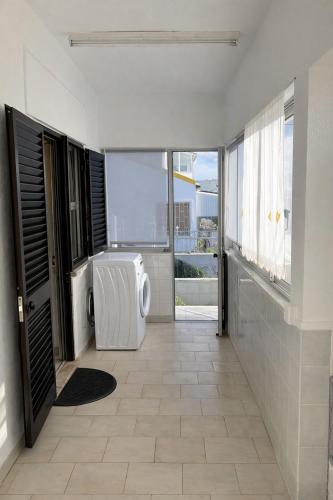 a bathroom with a washing machine in a room at Cozy Room in Corroios Near Beach & Lisbon - Quarto Acolhedor em Corroios Perto da Praia e Lisboa in Corroios
