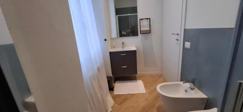 a bathroom with a white toilet and a sink at Casa Mafalda in Torre Boldone