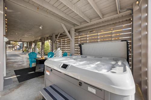 a large white tub in a room with a table and chairs at Channel Surfer in Myrtle Beach