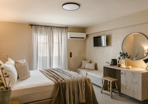 a hotel room with a bed and a mirror at Nomāde Agora Suites - Lixouri Town Centre, Kefalonia - Private Balconies in Lixouri