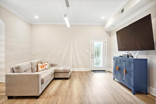 a living room with a couch and a flat screen tv at 2 Mi to Dtwn Jazz Clubs and Soul Food! NOLA Home in New Orleans