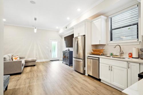 a kitchen with white cabinets and stainless steel appliances at 2 Mi to Dtwn Jazz Clubs and Soul Food! NOLA Home in New Orleans