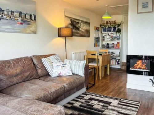 a living room with a couch and a dining room at Hillside in St Austell