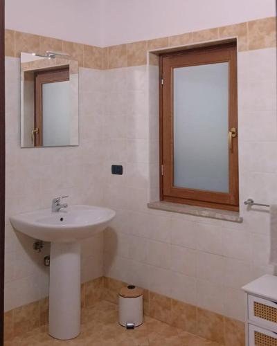 a bathroom with a sink and two mirrors at Residence Il Casolare in Piedimonte San Germano