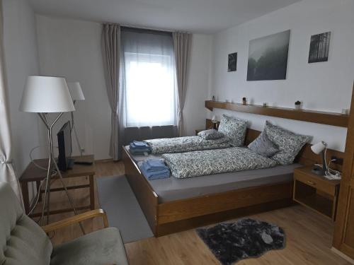 a living room with a bed and a window at Hotel Kaiser Friedrich in Bad Berleburg