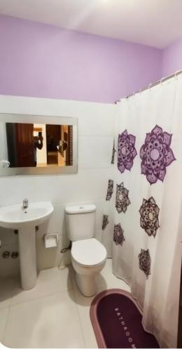 a bathroom with a toilet and a sink at Beach Village Rest in Tarrafal