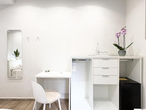 a white desk and a chair in a room at Napoleon in Tropea