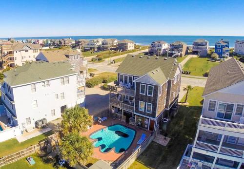 an aerial view of a neighborhood with houses and a pool at Happy Dog Days - Nags Head MP 11, Ocean View, 50 Yds to Beach, Elevator, Pool, Hot Tub, Pets OK, Flex Stays in Nags Head