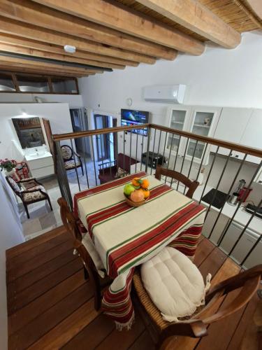 a table with fruit on top of a balcony at Cecilia Traditional House-Suites in Kalopanayiotis