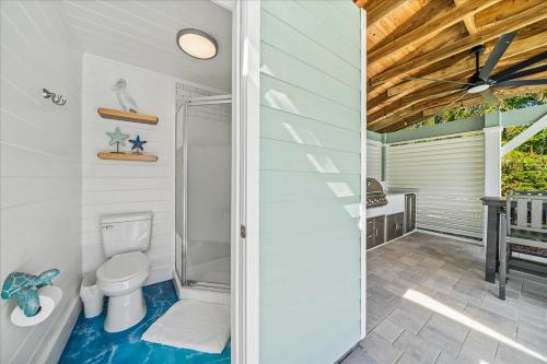 a bathroom with a toilet and a walk in shower at Private Pool, Backyard, and Steps to the Beach in Cocoa Beach