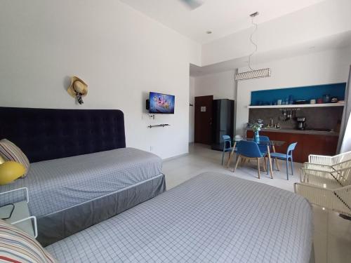a living room with a couch and a table at Nautica Apartment-4 guests and shared pool in Isla Mujeres
