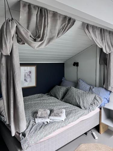 a bed with a canopy in a bedroom at Modern Luxplace with Northern Light view in Tromsø