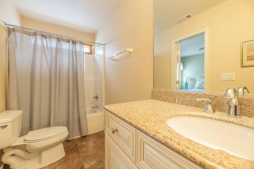 a bathroom with a sink and a toilet and a shower at Serenity in Nags Head - MP 11, Oceanfront, Ocean View, Pool, Hot Tub, Pets OK, YR Flex Stays in Nags Head