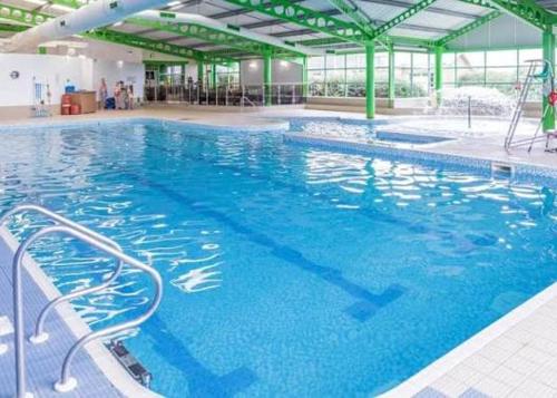 a large pool with blue water in a building at Westfield 75 in Skipsea