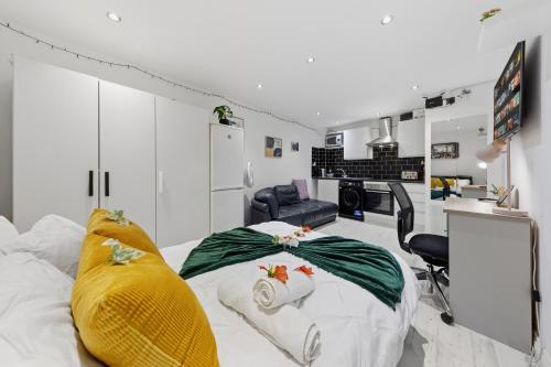 a bedroom with a bed and a living room at Studio Flat in Stepney-Limehouse - Central London in London