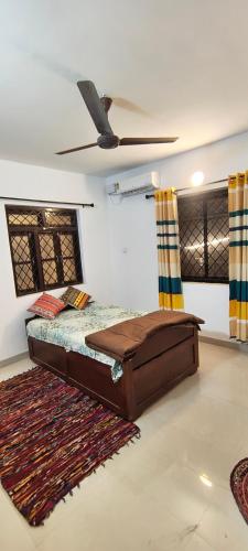 a bedroom with a bed and a ceiling at Minx guest house in Candolim