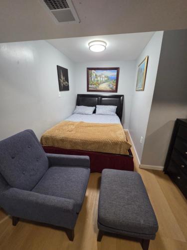 a bedroom with a bed and a chair at Executive private room in Irvington