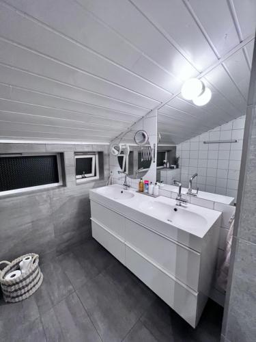 a bathroom with a large white sink and a mirror at Modern Luxplace with Northern Light view in Tromsø