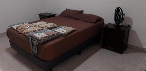 a bedroom with a bed with clothes on it at DeptoSarmiento in Paso de los Libres