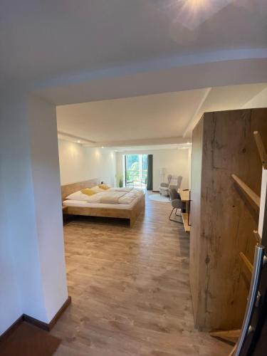 a bedroom with a bed and a desk in a room at Rhön-Hotel Sonnenhof - in Poppenhausen