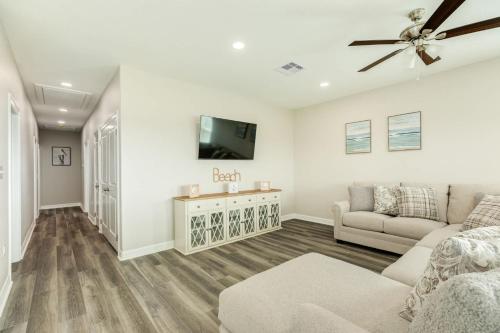 a living room with a couch and a tv at Minutes to Beach & Jetty Fishing Fun Get-a-way in Surfside Beach