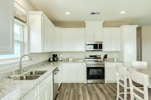 a white kitchen with white cabinets and a sink at Minutes to Beach & Jetty Fishing Fun Get-a-way in Surfside Beach