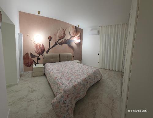 a bedroom with a bed and a painting on the wall at B&B Domus morfeo Caserta in Caserta