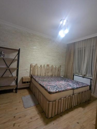 a bedroom with a large bed in a room at warm house in Tsqaltubo