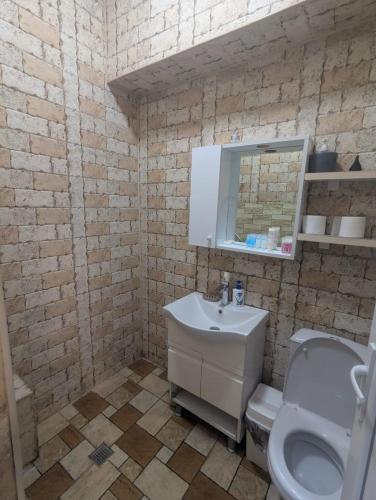 a bathroom with a sink and a toilet at warm house in Tsqaltubo