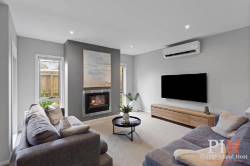 a living room with two couches and a flat screen tv at Townhouse with Shared Pool in Cowes in Cowes