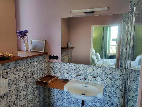a bathroom with a sink and a mirror at BellevueBretagne - Chambres d'Hôtes in Saint-Jean-du-Doigt