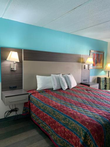 a hotel room with a large bed and a desk at Sky Suites in Tybee Island