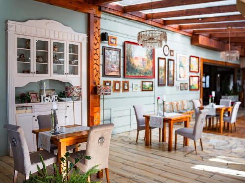 a dining room with wooden tables and chairs at Butikowy Hotel Zameczek in Książ Wielki