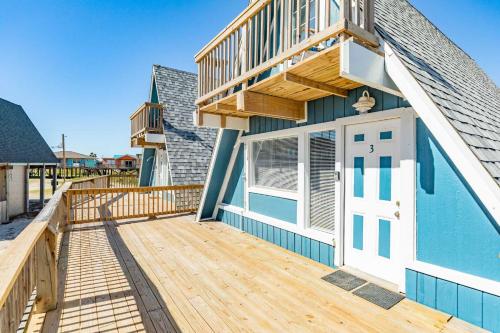 a house with a wooden deck with a white door at Come Enjoy the Best Beach View in Surfside in Surfside Beach