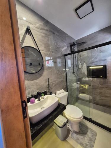 a bathroom with a sink and a toilet and a shower at Mirante Vista Nobre in Maricá