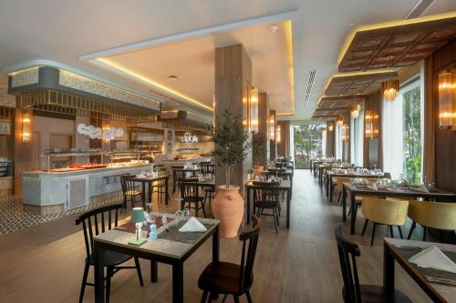 a restaurant with tables and chairs and a buffet at Riu Flamingos - All Inclusive in Nuevo Vallarta