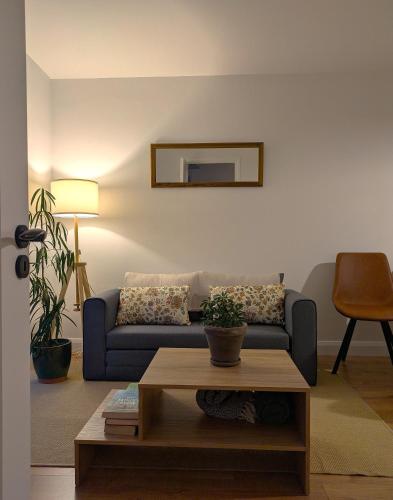 a living room with a blue couch and a table at Trim private rooms in Trim