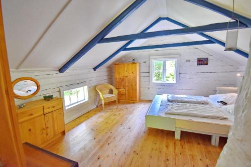 a bedroom with a bed and a desk in a room at "Björkhorva" in Vimmerby