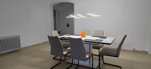 a dining room table with chairs and an orange cone on it at Luxury View in Westerburg